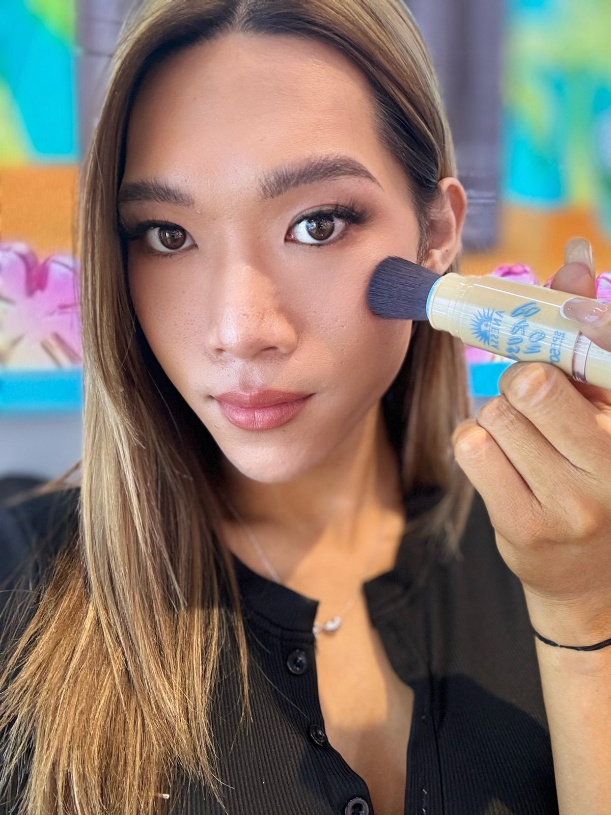 Maddie holding the Anessa Perfect UV Brush-on Powder