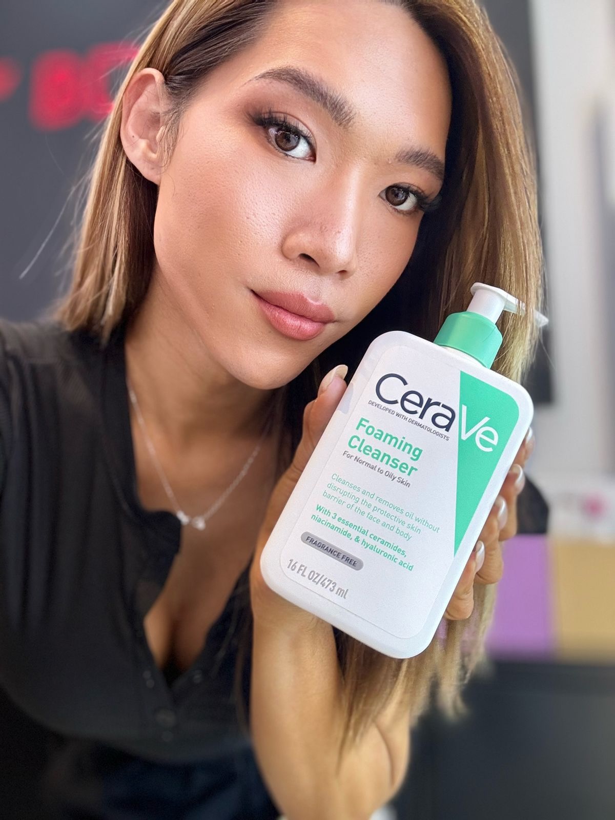 Maddie holding CeraVe Foaming Cleanser