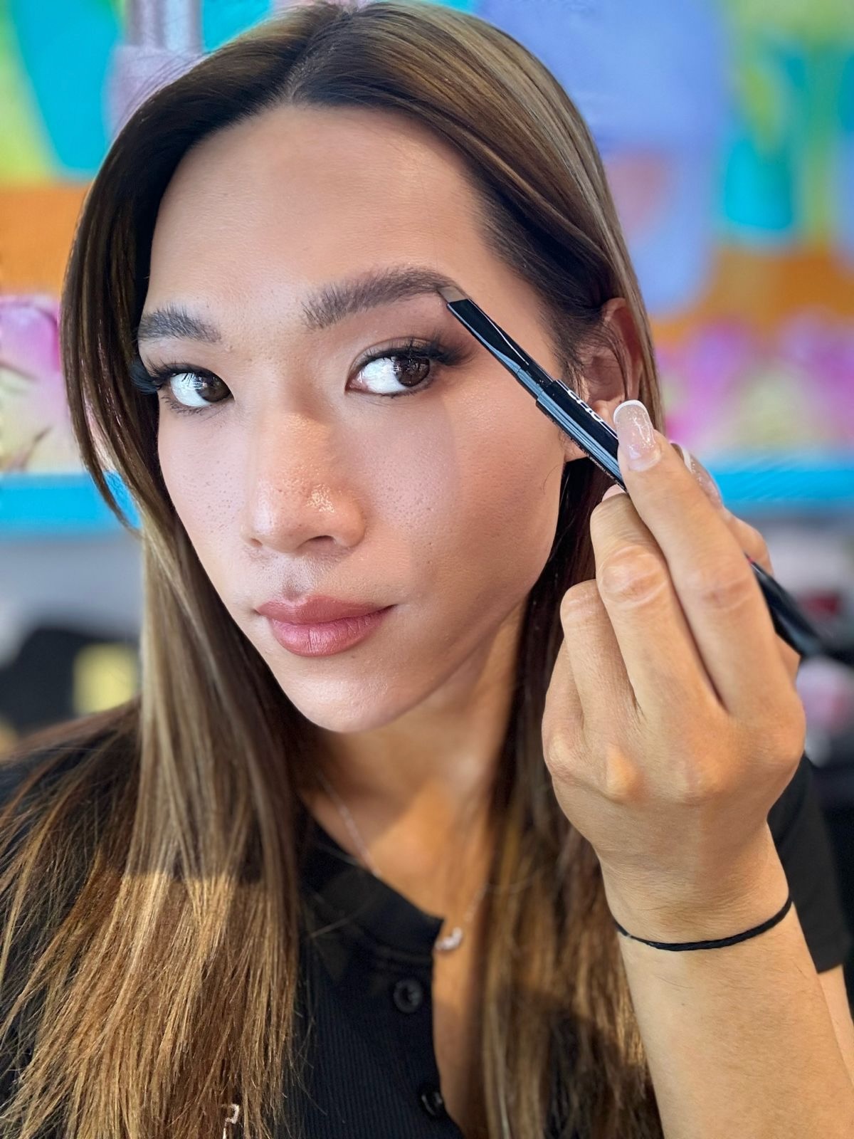 Maddie using the CLIO Kill Brow Auto Hard Brow Pencil on her brows