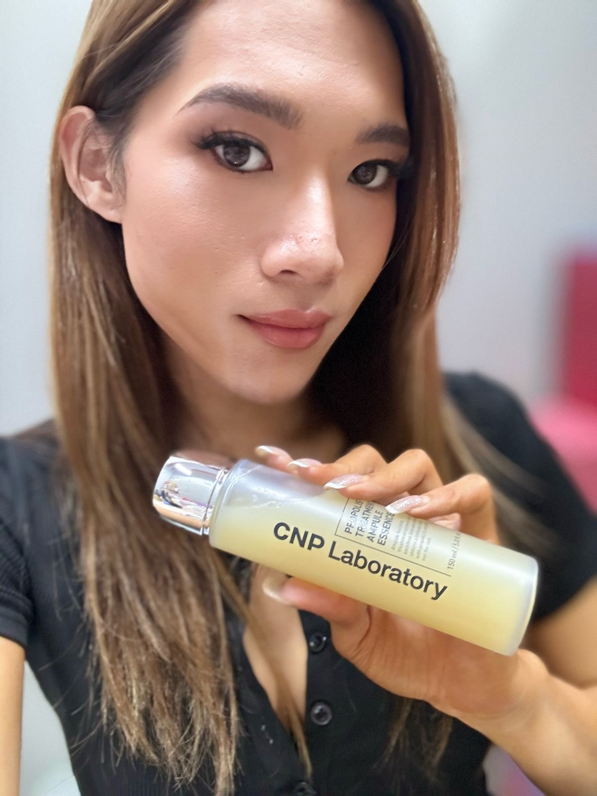 Maddie holding CNP Laboratory Propolis Treatment Ampule Essence