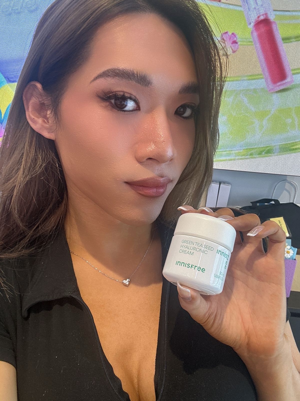 Maddie holding INNISFREE Green Tea Seed Hyaluronic Cream