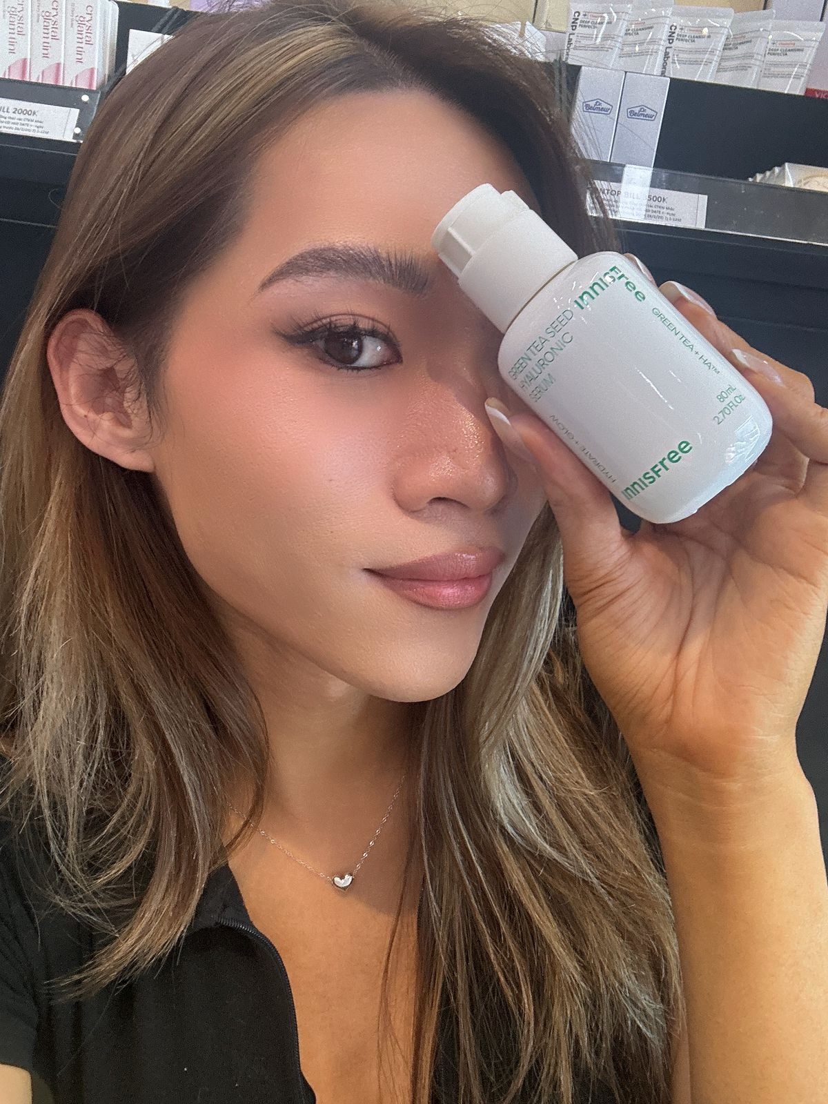 Maddie holding INNISFREE Green Tea Seed Hyaluronic Serum
